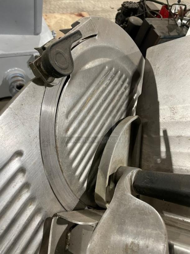 Hobart 1612E electric deli meat slicer, stainless steel, 115V, 1 phase, visible blade, lightly worn, commercial use.