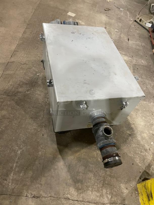 Commercial heavy-duty grease trap/interceptor, metal construction, used condition, visible pipe connection.
