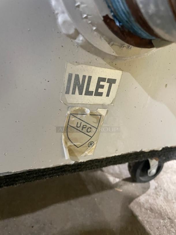 Commercial heavy-duty grease trap/interceptor with visible "INLET" label and UPC certification marking.