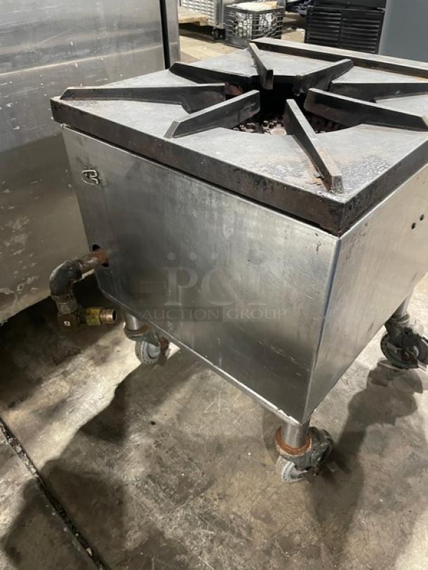 Commercial stainless steel gas-powered single burner stock pot range on casters. Functional condition, sturdy construction.