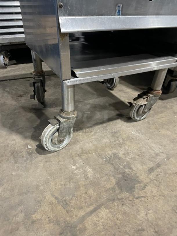 Commercial stainless steel gas-powered single burner stock pot range with casters, industrial kitchen equipment, good condition.