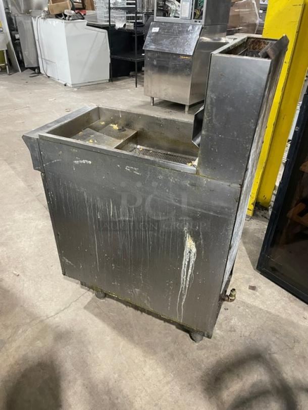 DCS stainless steel gas deep fryer with back splash, basket hanger, and legs. Shows signs of use; needs cleaning.