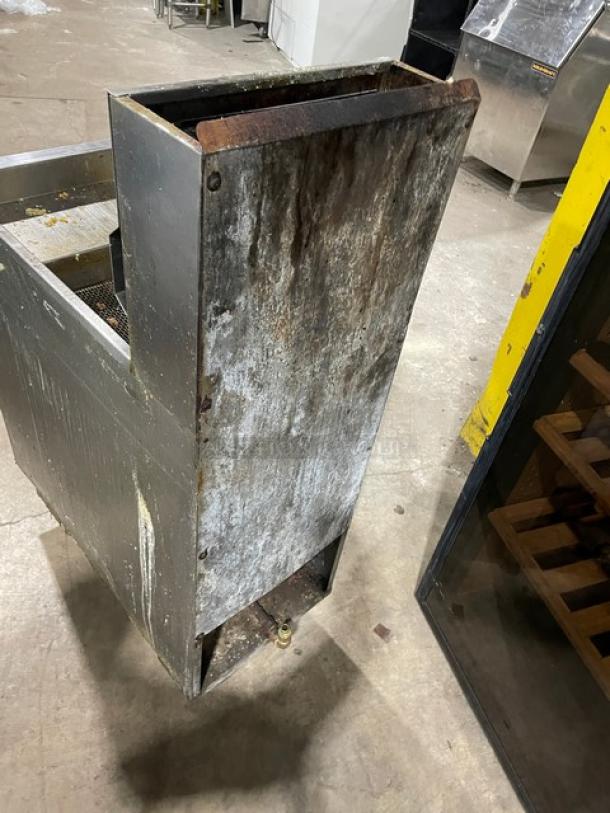 DCS commercial stainless steel gas deep fat fryer with backsplash, basket hanger, and legs. Visible wear and rust.