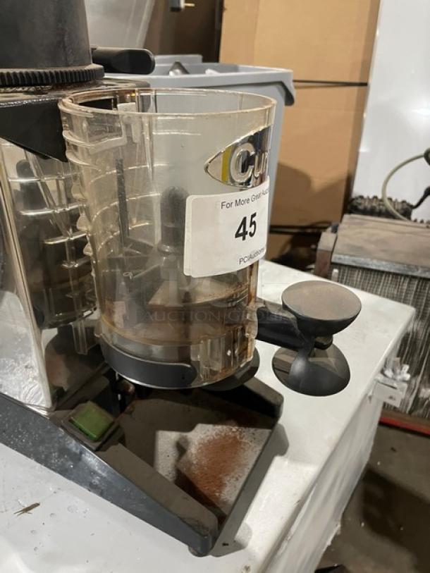 Cunill commercial electric countertop espresso bean grinder, visible wear, transparent hopper, serial number 845239, label marked 45.