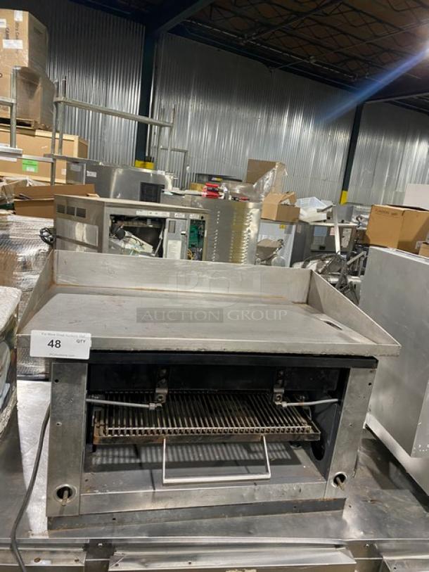 Commercial stainless steel gas-powered countertop flat-griddle with back and side splash, built-in broiler/cheese melter, lot tag "48".