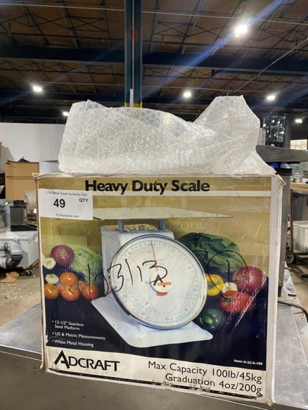 Adcraft SCA100 commercial 100 lb. portion control scale, new in box, with 13.5" stainless steel platform and metal housing.