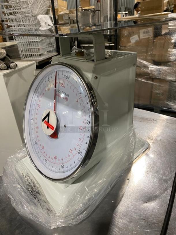 Adcraft SCA100 Commercial Scale, 100 lb capacity, white, new, 13.5" stainless steel platform, dial type, SN: J1310274974.