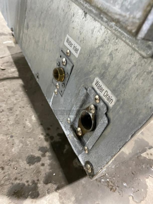 Icetro IU0220AH ice maker, showing water inlet and drain with labels. Stainless steel undercounter model on legs.