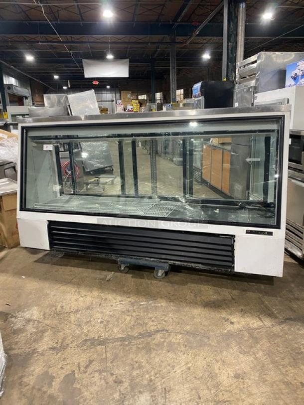 True TSID963 commercial white slanted glass deli merchandiser, 96", rear sliding doors, poly-coated rack, 115V, good condition.