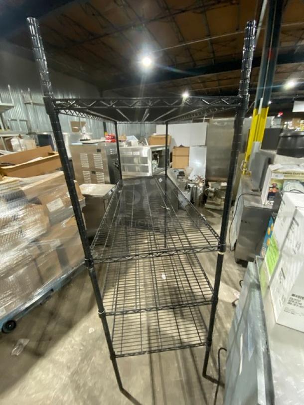 Commercial black multi-tier wired storage rack, utility shelving on legs, excellent condition, ideal for organizing.