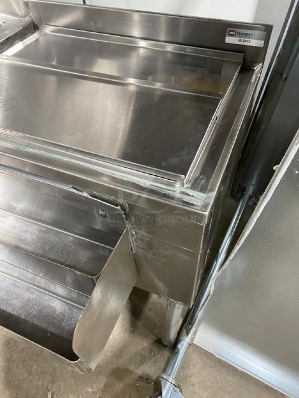 NBR Equipment stainless steel cocktail station with single compartment sink, drain board, sliding top ice bin, and double speed rail. Model: IB-2418/UW-1-1012-1521-TDV. On legs. Visible NBR Equipment label.