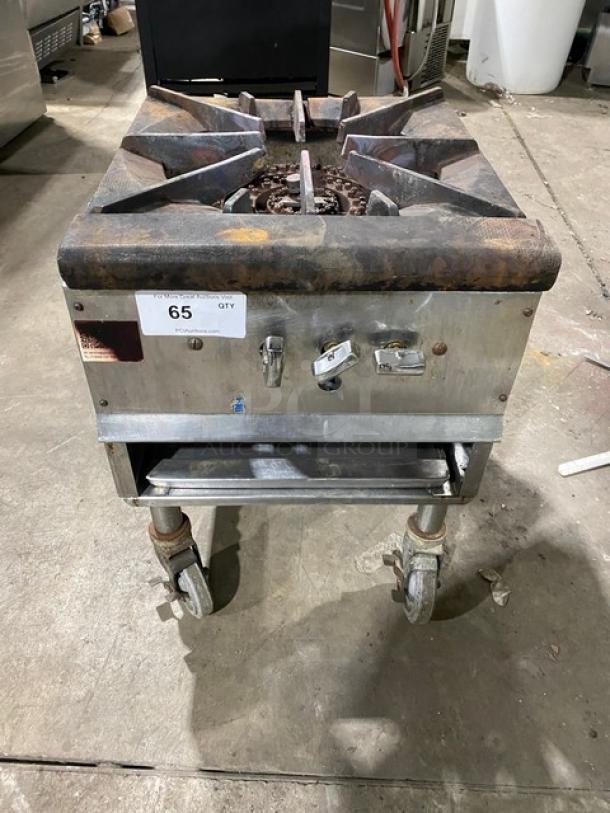 Commercial stainless steel gas-powered single burner stock pot range on casters, visible wear, item number 65.