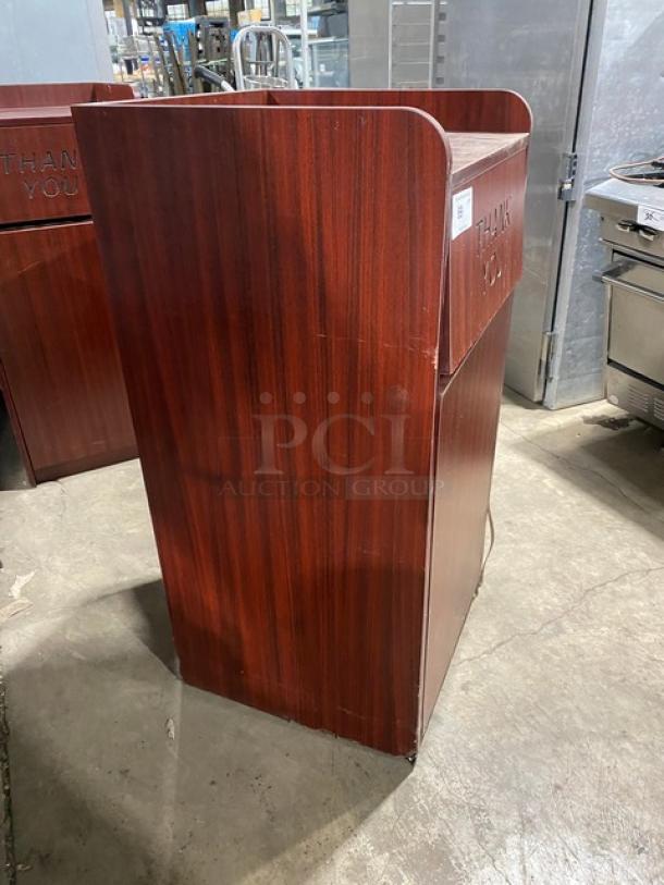 Commercial wooden trash cabinet, "Thank You" engraving, enclosed receptacle, dark wood finish, used condition.