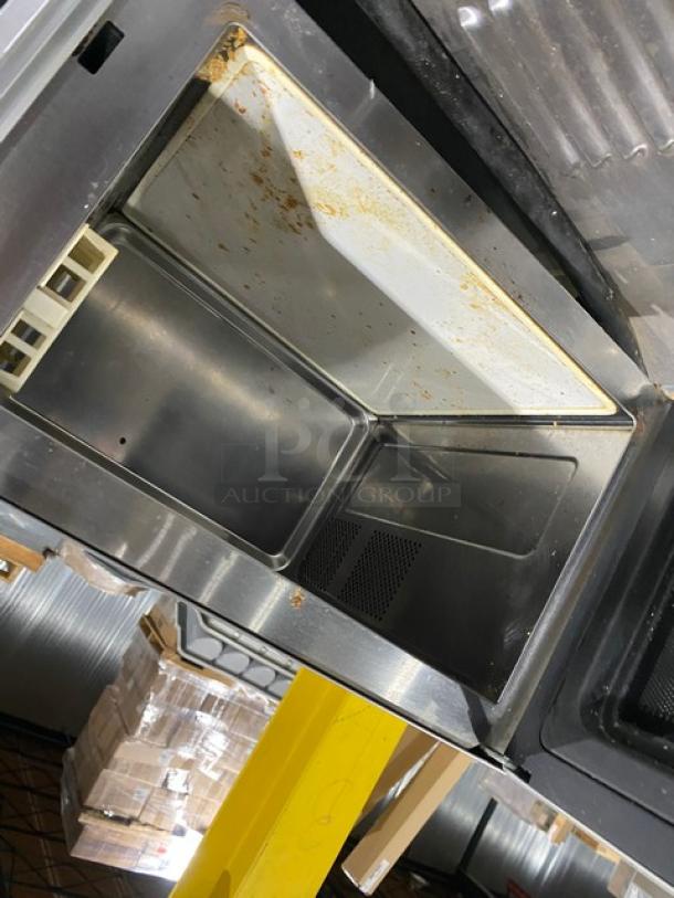 Amana RMS10DS stainless steel commercial microwave, 120V, countertop model, shows interior wear, ideal for industrial use.