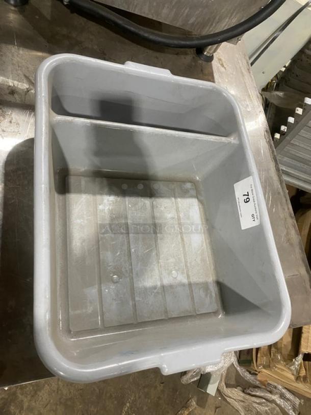 Soft gray commercial divided bus tub with dual compartments. Gently used, sturdy plastic. Auction tag labeled "79." Ideal for restaurant use.