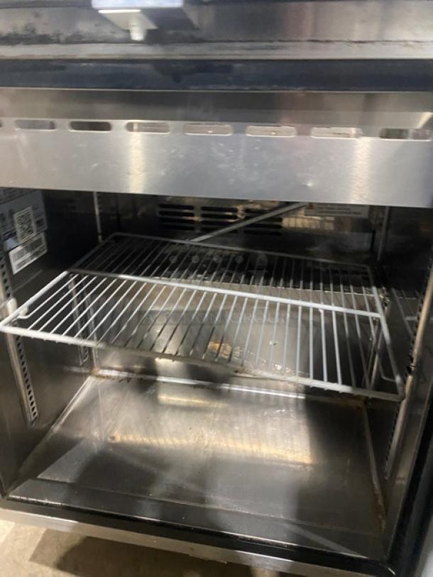 Turbo Air MST-28-N-711S stainless steel single door refrigerated prep table with sneeze guard and poly-coated rack. 115V 1 Phase.