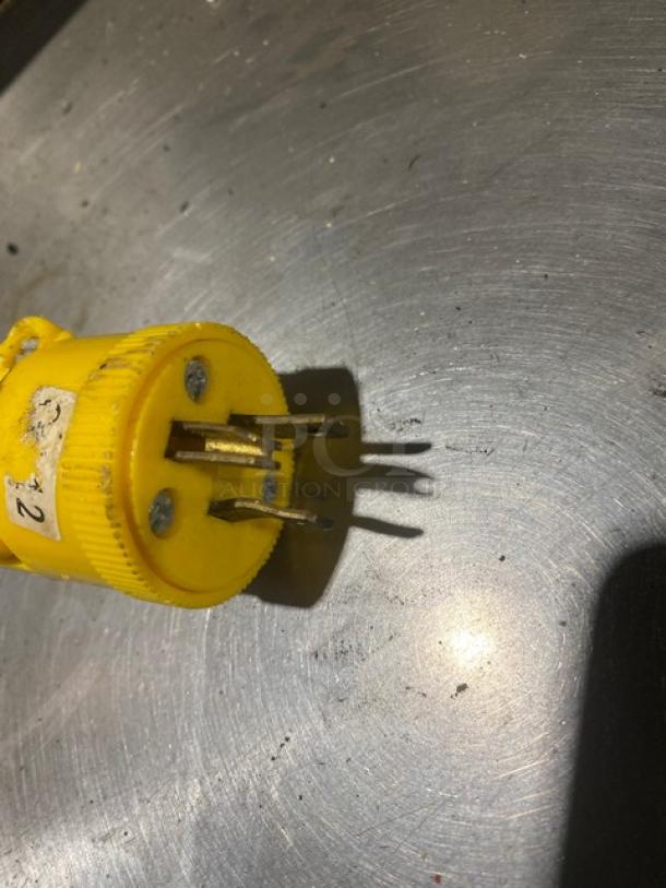 Yellow power plug for Acme 7 Series pizza dough roller, showing three-prong design and number "2" label.