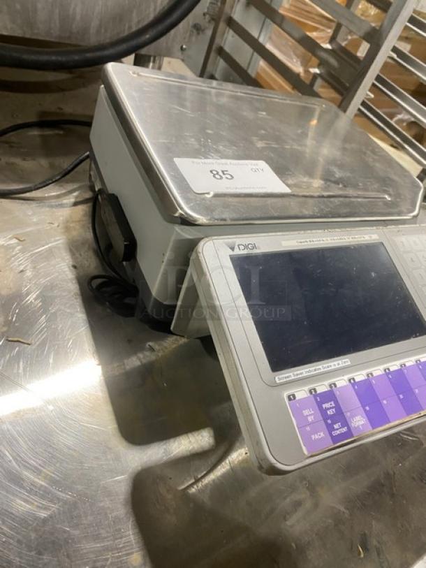 Digi SM5000 commercial stainless steel countertop labeling scale, electric-powered, good condition, with digital display.