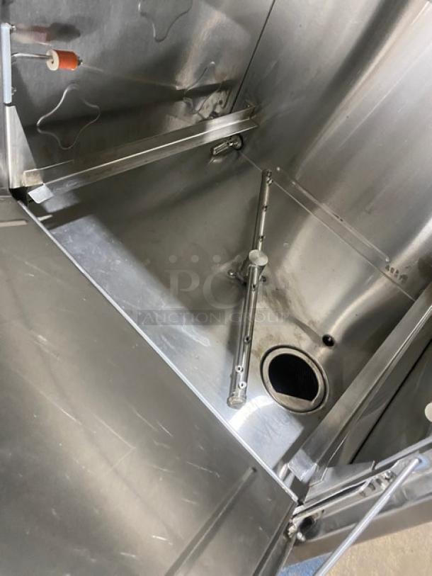 CMA Energy-Mizer L1X16 stainless steel undercounter dishwasher interior, featuring heater and spray arms, in good condition.