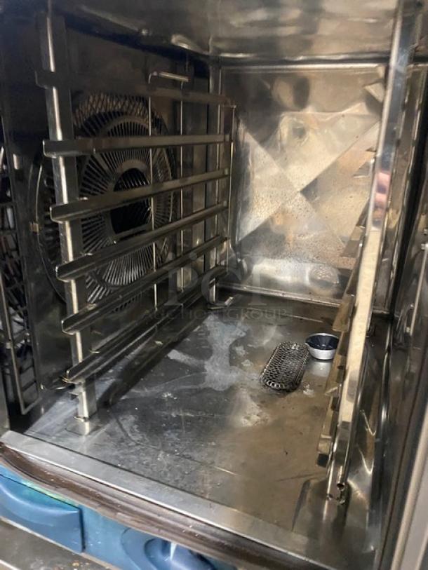 Rational Self Cooking Center 5Senses commercial combi oven, stainless steel interior, built-in pan slides, gas-powered, on casters.