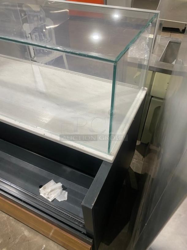 Structural Concepts Model SBZ6652DR black refrigerated merchandiser with glass top and rear access sliding doors, 220V, on legs.