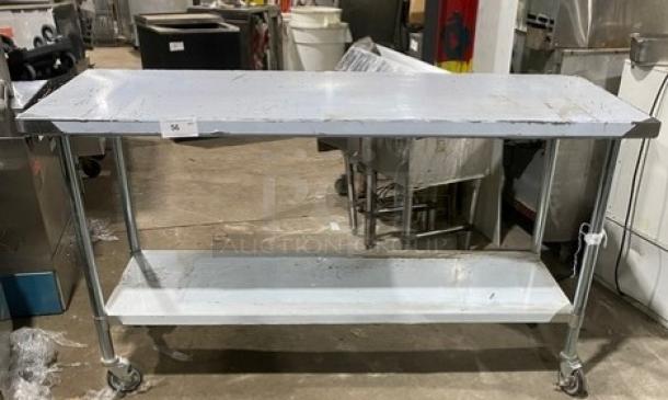 Commercial stainless steel worktop table with undershelf and casters. Durable, mobile, ideal for kitchens. Good condition.