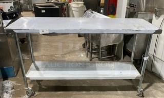 Commercial stainless steel worktop table with undershelf and casters. Durable, mobile, ideal for kitchens. Good condition.