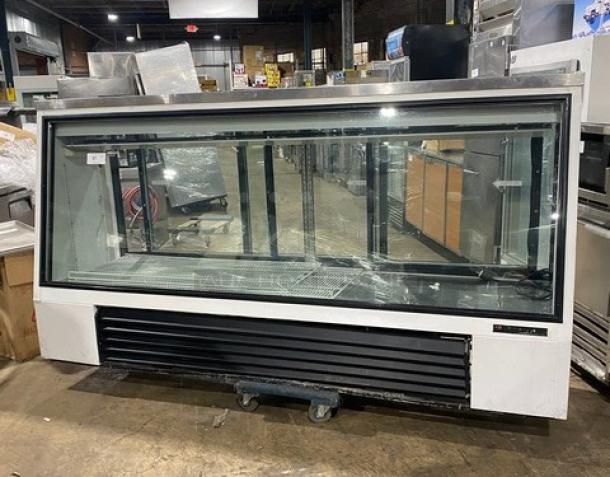 True TSID963 commercial white slanted glass deli merchandiser, 96", rear sliding doors, poly-coated rack, 115V, good condition.
