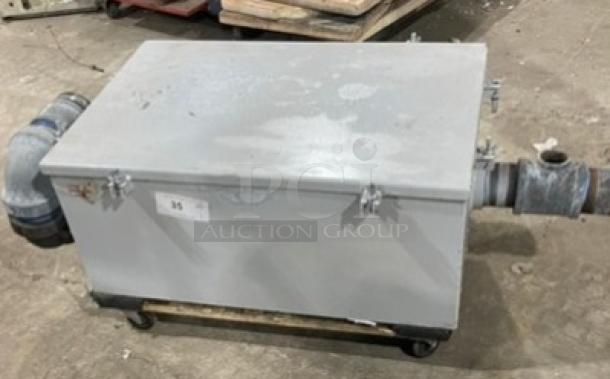 Commercial heavy-duty grease trap/interceptor, rectangular metal body, attached piping, used condition with surface wear.