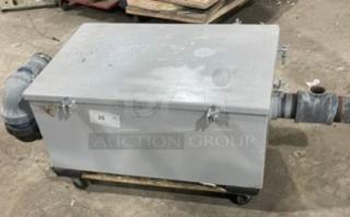 Commercial heavy-duty grease trap/interceptor, rectangular metal body, attached piping, used condition with surface wear.