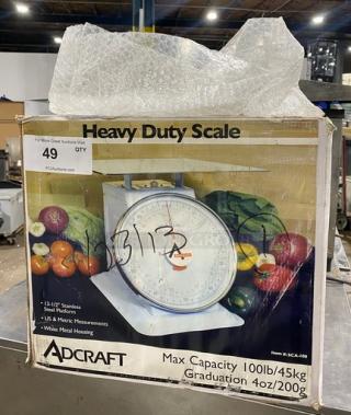 Adcraft SCA100 commercial 100 lb. portion control scale, new in box, with 13.5" stainless steel platform and metal housing.
