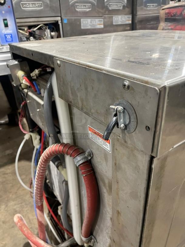 Hobart LXI Series stainless steel undercounter dishwasher, electric powered, Energy Star certified, visible wiring, on legs.