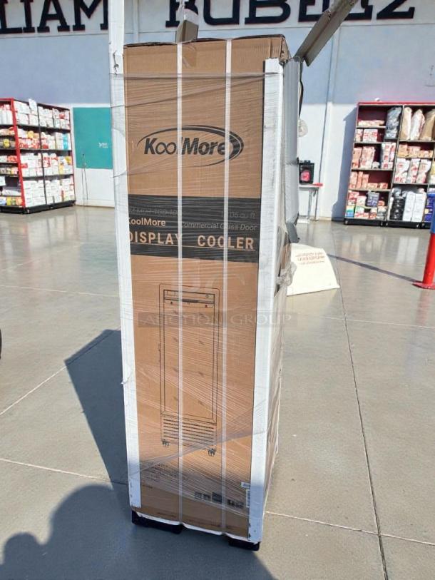 KoolMore Commercial Glass Door Display Refrigerator, model MDR1GD12C. Brand new, scratch and dent condition, packaging visible.
