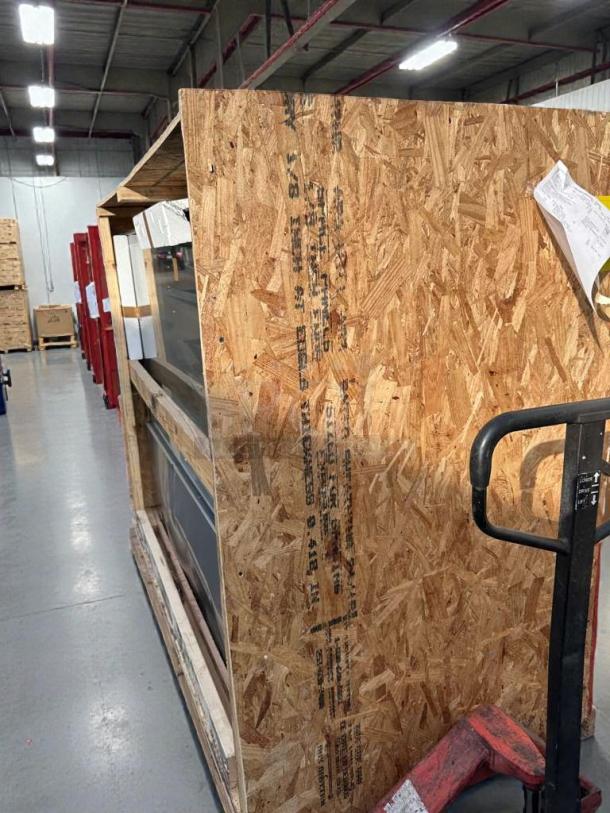 Brand new KoolMore refrigerated bakery display case packaged in crate. Model KML-L-BDC-0031, minor scratches.