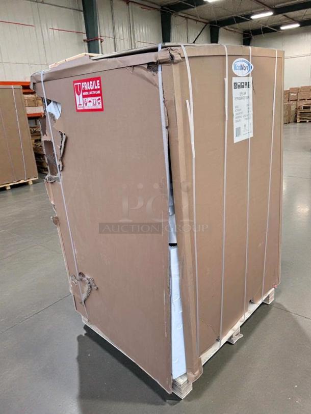 Brand new Koolmore CDA-13C refrigerated merchandiser in packaging with visible dents. Fragile handle with care label.