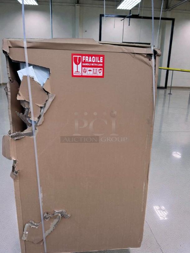 Damaged packaging of a Koolmore Open Air Refrigerated Display Merchandiser, model CDA-13C. "Fragile" label visible.