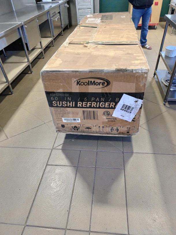 Damaged Koolmore 60" Glass Sushi Countertop Display Refrigerator, Model KM-SR60-BK, in box with visible wear and shipping labels.