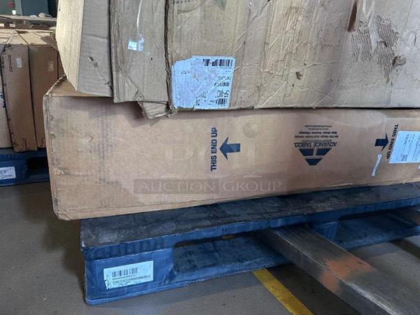 Brand new Advance Tabco stainless steel work table, model KLAG-304-X, in original packaging with visible dents.