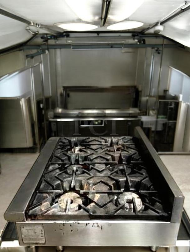 Wolf AHP636 36" gas hotplate with 6 burners in excellent condition. Tested, working, natural gas. Model plaque visible.