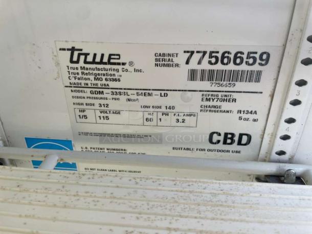 Label of True GDM-33SSL-54-EM-LD merchandiser fridge. Shows model info, voltage 115V, refrigerant R134A, made in USA.