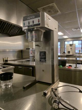 Pristine FETCO TBS-21A commercial tea brewer, 120V, silver finish, fully tested, model shown in a kitchen setting.