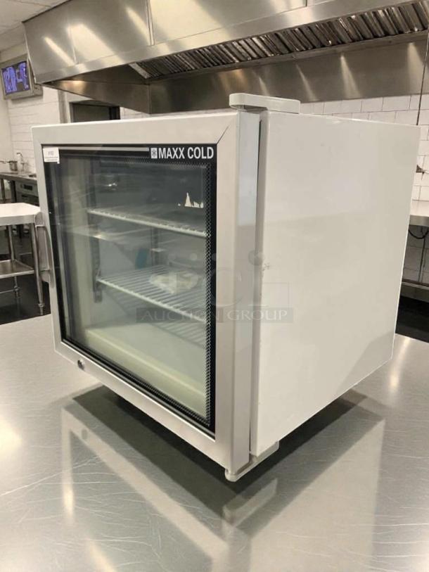 Maxx Cold MXM1-2F commercial countertop freezer, glass door, refined condition, fully tested, visible shelves inside.