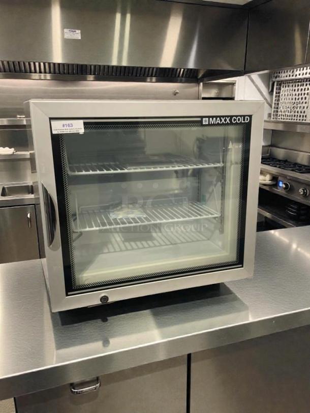 Maxx Cold MXM1-2F commercial countertop freezer, refined condition, fully tested. Features glass door and stainless steel build.
