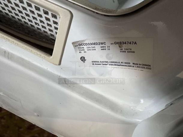 Immaculate GE coin-operated dryer, model DCCD330ED2WC. Voltage: 120/208-240V, fully tested and working, tag details visible.
