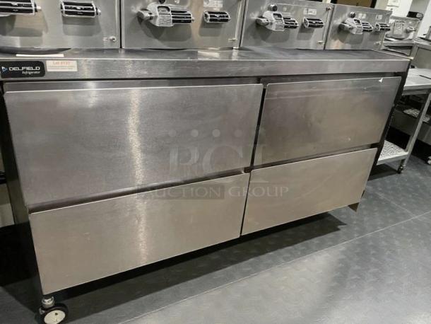 Immaculate Delfield GUR60BP-D undercounter refrigerator, stainless steel, 115V, tested, with label indicating model and lot #137.