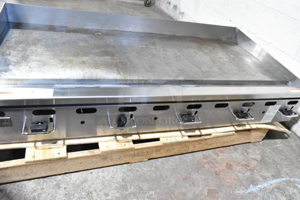 Brand new Wolf AGM60-101 stainless steel 60" commercial gas griddle, manual controls, 135,000 BTU, natural gas, minor scratches.