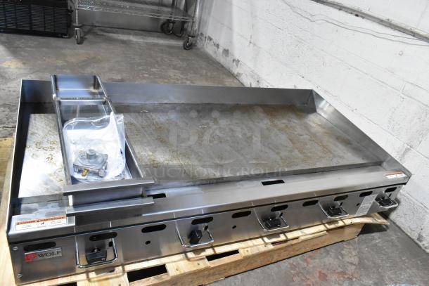 Brand new Wolf AGM60-101 stainless steel 60" gas countertop griddle, 135,000 BTU, manual controls, minor scratches.