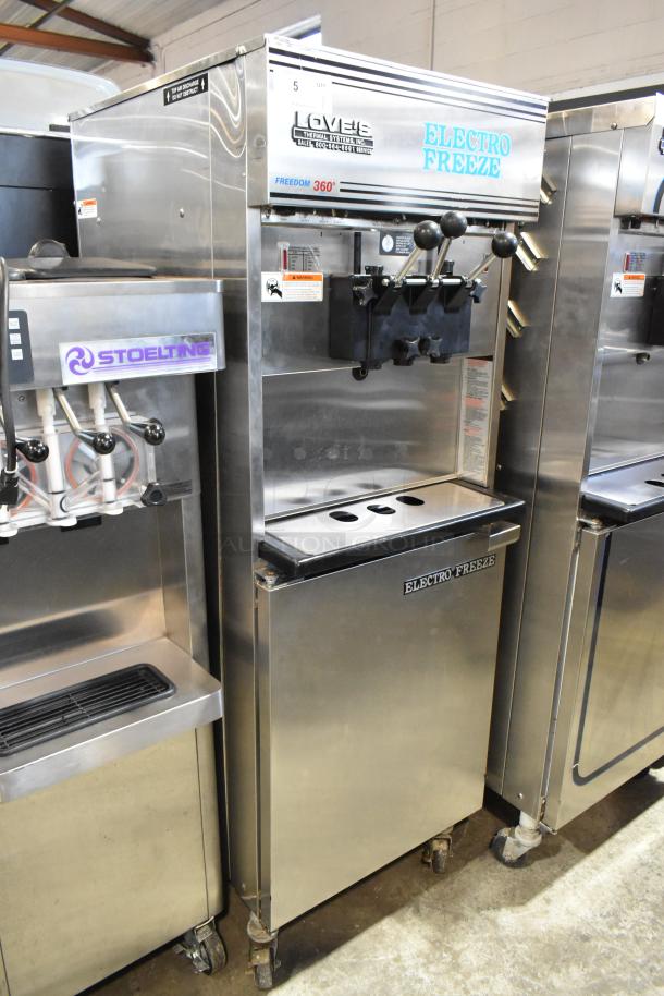 Electro Freeze 99T-RMT-137 stainless steel soft serve ice cream machine, 2 flavors with twist, on commercial casters.