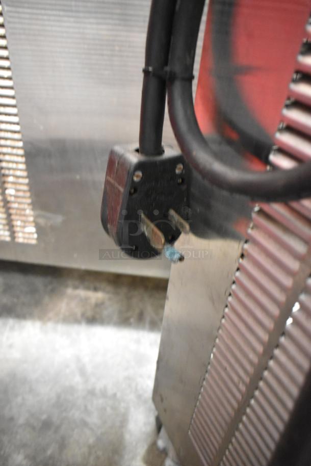 Close-up of a plug on the Electro Freeze 99T-RMT-137 stainless steel soft serve ice cream machine.