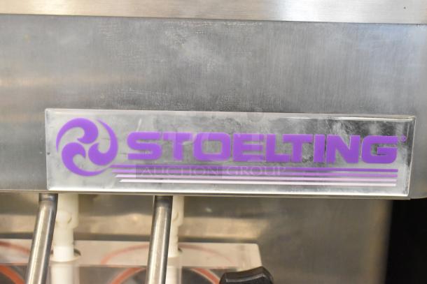 Stoelting F231-18I2YGAD1 stainless steel soft serve machine, featuring dual flavors with twist, on commercial casters.